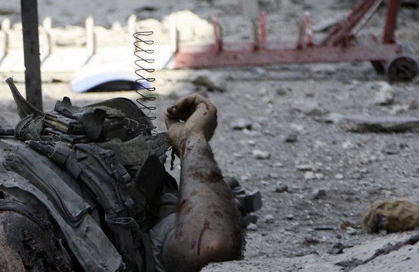 dead Lebanese soldier lies on a street at Adaisseh village, southern Lebanon August 3, 2010. An Israeli helicopter on Tuesday fired two missiles at a Lebanese army post near the southern border village of Adaisseh, destroying an armoured personnel carrier, a security source said. A Lebanese journalist and three Lebanese soldiers died after the Israeli and Lebanese armies exchanged fire in the border area, a security source said.