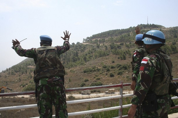 U.N. peacekeepers gesture and shout at Israeli soldiers on the Lebanese-Israeli borders near Adaisseh village, southern Lebanon, August 3, 2010. Israeli artillery shelled a Lebanese village Tuesday, wounding two people, after Lebanese Army troops fired warning shots at Israeli soldiers along the usually quiet but tense frontier, witnesses said