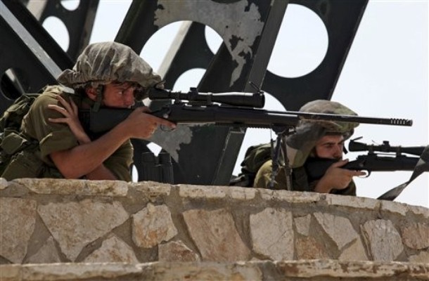 Israeli soldiers look through the sights of their weapons from a position in northern Israel overlooking the Israeli-Lebanese border, Tuesday, Aug. 3, 2010. Lebanese and Israeli troops exchanged fire on the border Tuesday in the most serious clashes since a fierce war four years ago, and Lebanon said at least two of its soldiers and a journalist were killed in shelling.